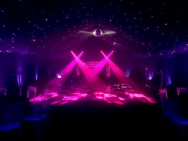 Marquee with blackout drapes, starlit ceiling, mirrorball, chequered dancefloor, uplighting & premium disco package.
